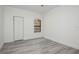 Bright bedroom with light gray floors, a window, and a closet at 2171 Portofino Place # 27-2725, Palm Harbor, FL 34682