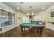 Billiard room featuring a pool table, lounge seating, and natural light from large windows at 2171 Portofino Place # 27-2725, Palm Harbor, FL 34682
