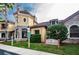 Beautiful clubhouse exterior with stone accents, lush landscaping, and clear signage at 2171 Portofino Place # 27-2725, Palm Harbor, FL 34682