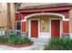 Front exterior view of townhome entrance with two red doors at 2171 Portofino Place # 27-2725, Palm Harbor, FL 34682