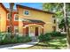 Charming two-story villa showcasing a covered entrance, well-maintained landscaping, and a welcoming facade at 2171 Portofino Place # 27-2725, Palm Harbor, FL 34682