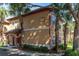 Well-maintained villa with lush landscaping and a clear unit number, surrounded by mature palm trees and greenery at 2171 Portofino Place # 27-2725, Palm Harbor, FL 34682