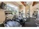 Well-equipped gym with treadmills, elliptical, and ceiling fan with large windows and tv at 2171 Portofino Place # 27-2725, Palm Harbor, FL 34682