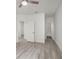 Hallway leading to a bedroom and bathroom featuring luxury vinyl plank flooring at 2171 Portofino Place # 27-2725, Palm Harbor, FL 34682