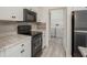 Modern kitchen with stainless steel appliances, light countertops, and white cabinetry, conveniently located near the laundry area at 2171 Portofino Place # 27-2725, Palm Harbor, FL 34682