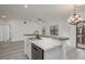 Bright and airy kitchen with a breakfast bar, stainless steel dishwasher, granite countertops, and luxury vinyl plank flooring at 2171 Portofino Place # 27-2725, Palm Harbor, FL 34682