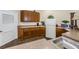 Amenity Center kitchen with wooden cabinets, appliances, and countertops at 2171 Portofino Place # 27-2725, Palm Harbor, FL 34682