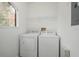 Functional laundry room with washer and dryer, with a bright window at 2171 Portofino Place # 27-2725, Palm Harbor, FL 34682