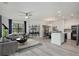 Bright, open-concept living area featuring luxury vinyl plank flooring and a modern kitchen with stainless steel appliances at 2171 Portofino Place # 27-2725, Palm Harbor, FL 34682