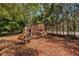 Community playground featuring slides, climbing structures, and wood chip ground cover at 2171 Portofino Place # 27-2725, Palm Harbor, FL 34682
