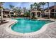 Beautiful pool area with waterfall feature and lounge chairs, perfect for relaxing outdoors at 2171 Portofino Place # 27-2725, Palm Harbor, FL 34682