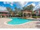 Resort-style pool area with a waterfall feature and poolside lounge chairs at 2171 Portofino Place # 27-2725, Palm Harbor, FL 34682