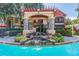Stunning pool area with rock waterfall feature and lush landscaping in a community setting at 2171 Portofino Place # 27-2725, Palm Harbor, FL 34682