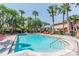 Community pool surrounded by lush landscaping and comfortable lounge chairs for relaxation at 2171 Portofino Place # 27-2725, Palm Harbor, FL 34682