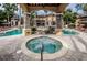 Stunning community pool and jacuzzi area with beautiful landscaping and outdoor seating, perfect for relaxation at 2171 Portofino Place # 27-2725, Palm Harbor, FL 34682