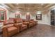 Inviting home theater with tiered seating in comfortable leather recliners and warm wood flooring at 2171 Portofino Place # 27-2725, Palm Harbor, FL 34682