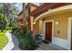 Attractive villa with covered entrance, tidy landscaping, and a pathway leading to the front door, creating a welcoming feel at 2171 Portofino Place # 27-2725, Palm Harbor, FL 34682