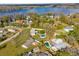 Overhead view of a lakeside neighborhood, highlighting homes with private pools and lush landscaping at 21826 Pineywood Loop, Land O Lakes, FL 34639