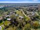 Tranquil lake views are captured in this aerial shot of a residential community surrounded by trees at 21826 Pineywood Loop, Land O Lakes, FL 34639