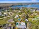 Lakefront homes are visible in this aerial photograph featuring lush green foliage, and swimming pools at 21826 Pineywood Loop, Land O Lakes, FL 34639