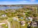 An aerial view of a neighborhood with a lake, showing homes with pools and spacious yards at 21826 Pineywood Loop, Land O Lakes, FL 34639