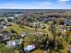 An elevated view displays a residential community near a serene lake, enhanced by vibrant greenery at 21826 Pineywood Loop, Land O Lakes, FL 34639