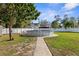 An inground pool with a surrounding brick paver walkway sits in the back yard of this home at 21826 Pineywood Loop, Land O Lakes, FL 34639