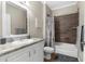 Well lit bathroom featuring tile backsplash, modern fixtures, and coordinated textiles at 21826 Pineywood Loop, Land O Lakes, FL 34639