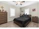 This bedroom is well-lit and furnished with a full-sized bed, a dresser, and two nightstands at 21826 Pineywood Loop, Land O Lakes, FL 34639