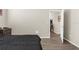 View of bedroom with view into hall area, simple decor, and comfortable textiles at 21826 Pineywood Loop, Land O Lakes, FL 34639