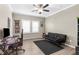 Bedroom featuring natural light, a ceiling fan, wood-look floors, and a black futon sofa at 21826 Pineywood Loop, Land O Lakes, FL 34639