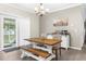 Eat-in dining area featuring a wood table and chairs with a view of the outdoors through a sliding glass door at 21826 Pineywood Loop, Land O Lakes, FL 34639