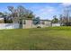 Front view of a single-story home showcasing a well-kept lawn and a light-colored privacy fence at 21826 Pineywood Loop, Land O Lakes, FL 34639