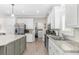 Modern kitchen featuring white cabinets, stainless steel appliances, and granite countertops at 21826 Pineywood Loop, Land O Lakes, FL 34639