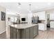Open kitchen with a large island, stainless appliances, and a view of the living room at 21826 Pineywood Loop, Land O Lakes, FL 34639