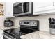 Modern kitchen features a stainless steel stove and appliances, and light countertops at 21826 Pineywood Loop, Land O Lakes, FL 34639