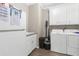 Functional laundry room with white cabinets, modern appliances, and convenient storage solutions at 21826 Pineywood Loop, Land O Lakes, FL 34639