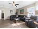 Cozy living room with a ceiling fan, a comfortable sofa, and lots of natural light at 21826 Pineywood Loop, Land O Lakes, FL 34639