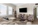 Bright living room features wood floors, plantation shutters, and a decorative console at 21826 Pineywood Loop, Land O Lakes, FL 34639