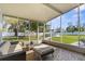 The screened patio provides a relaxing outdoor living space with nice furniture and a view of the backyard at 21826 Pineywood Loop, Land O Lakes, FL 34639