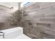 Shower featuring stylish tiling, a white base, and contemporary shower fixtures at 21826 Pineywood Loop, Land O Lakes, FL 34639