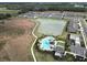 Aerial view of neighborhood pool, lake and residential area at 2411 Paravane Way, Wesley Chapel, FL 33543