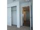 Bedroom featuring a door to the hallway and a closet with sliding doors at 2411 Paravane Way, Wesley Chapel, FL 33543
