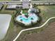 Aerial view of the community pool with seating and landscaping at 2411 Paravane Way, Wesley Chapel, FL 33543