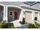 Townhouse exterior featuring a private garage, a covered porch, and well-maintained landscaping at 2411 Paravane Way, Wesley Chapel, FL 33543