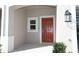 Inviting front door with a covered porch, modern lighting, and views of the private garage at 2411 Paravane Way, Wesley Chapel, FL 33543