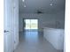 Open-concept gathering room featuring tile flooring, modern ceiling fan, and sliding door access to the outdoors at 2411 Paravane Way, Wesley Chapel, FL 33543