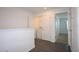 Second floor hallway leading to bedrooms and laundry area; note the wood flooring at 2411 Paravane Way, Wesley Chapel, FL 33543