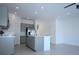 Spacious kitchen with stainless steel appliances, gray cabinets, and central island at 2411 Paravane Way, Wesley Chapel, FL 33543