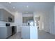 Modern kitchen featuring stainless steel appliances and a central island at 2411 Paravane Way, Wesley Chapel, FL 33543